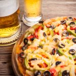 pizza on the table with a glass of beer