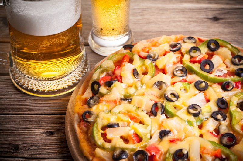 pizza on the table with a glass of beer
